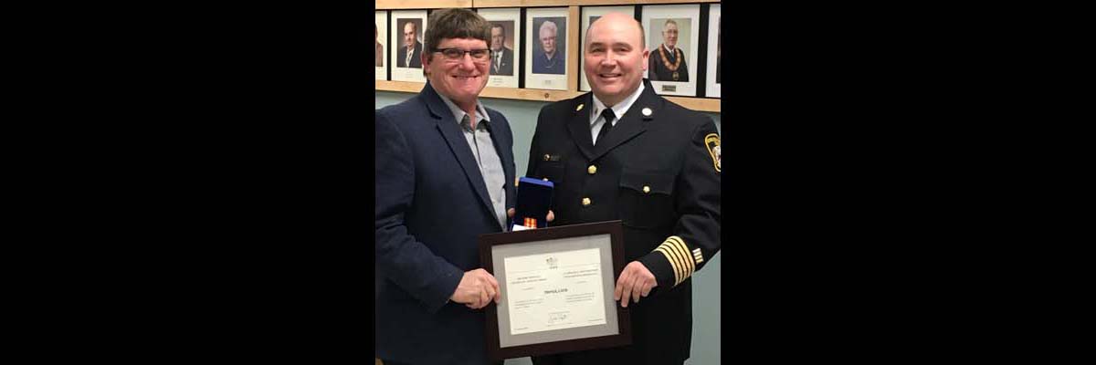 Fire Chief Derrick Little receiving his 20 year award
